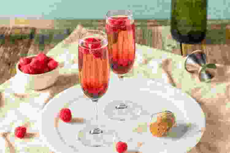 Kir Royale, a red Thanksgiving cocktail in tall glasses. 