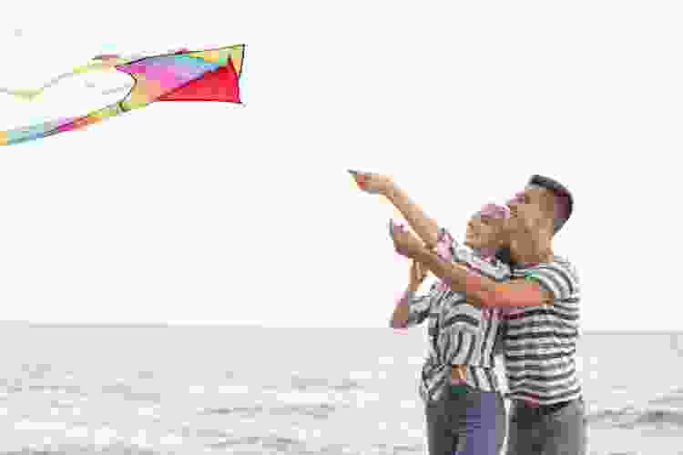 couple flying kite on the beach