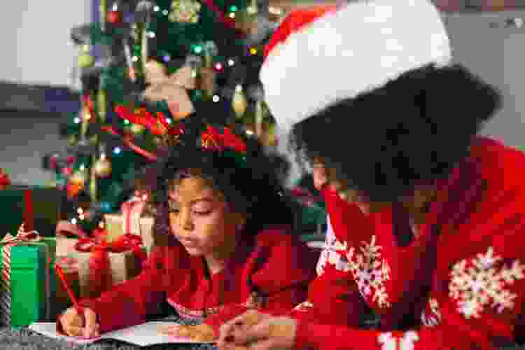 child and mother writing letter to Santa for a fun Christmas activity for kids