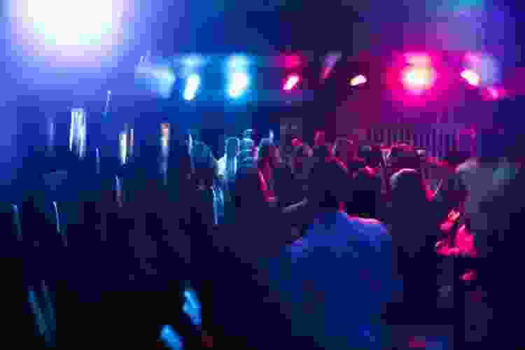 line dancers at a club with purple and blue lights