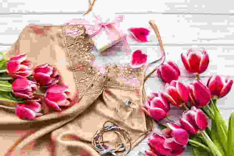 set of silky lingerie surrounded by pink flowers