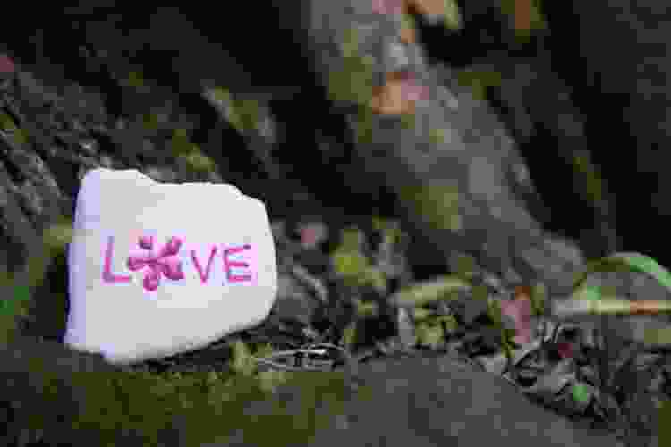 small rock with the word love painted in pink