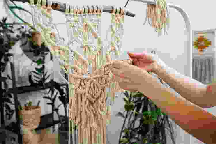 hands crafting macrame art for DIY home décor