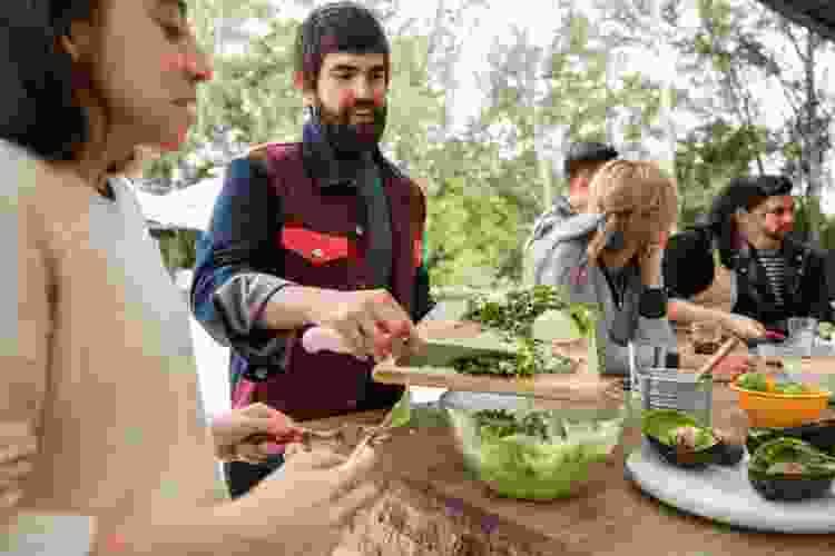 group of people making guacamole