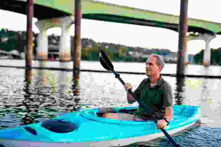 man kayaking in river