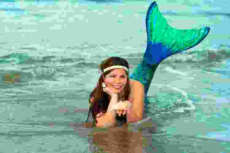 woman dressed as mermaid on the beach