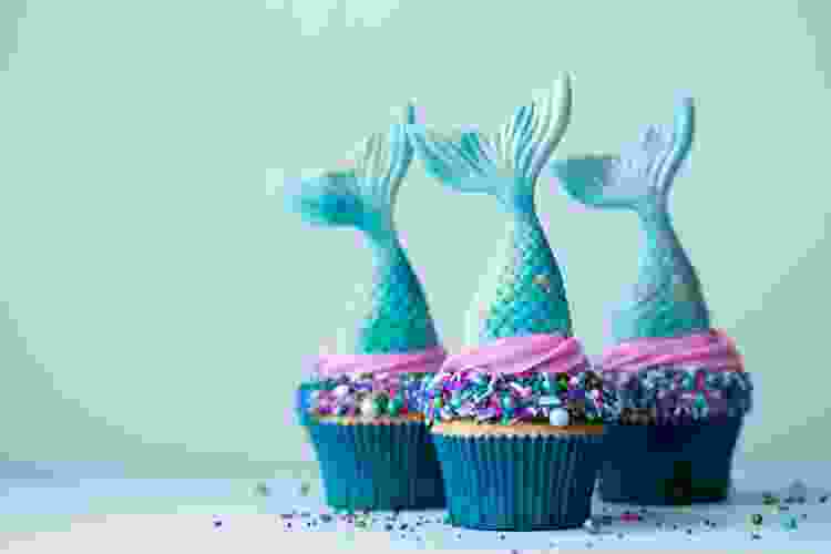 purple cupcakes with mermaid tail toppers