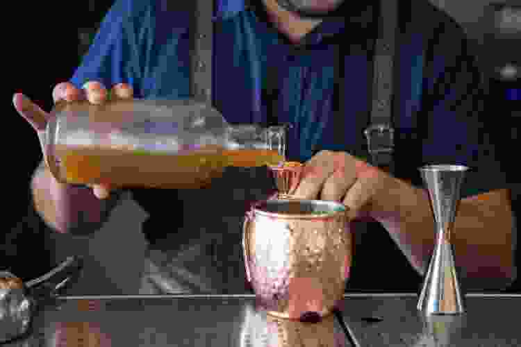 making cocktail in copper cup