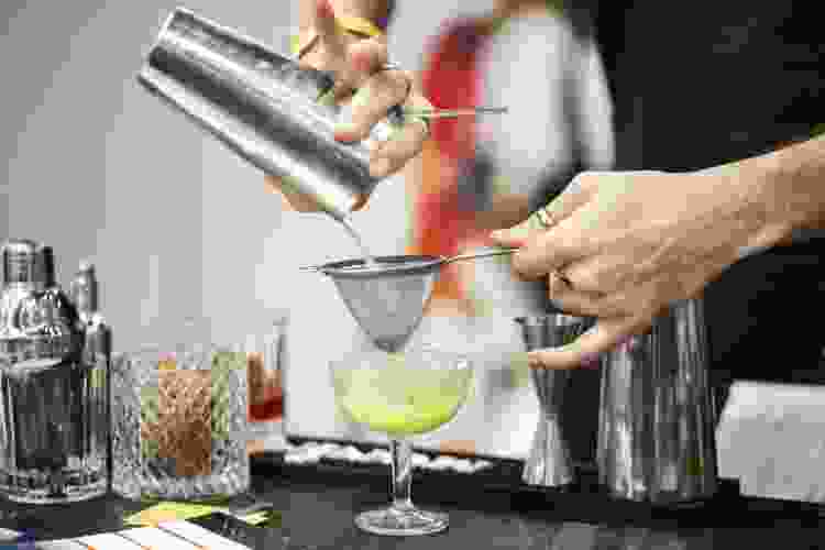 pouring cocktail from shaker