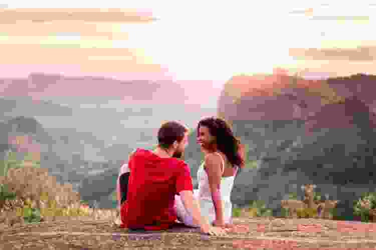 couple watching the sunset over the mountain range