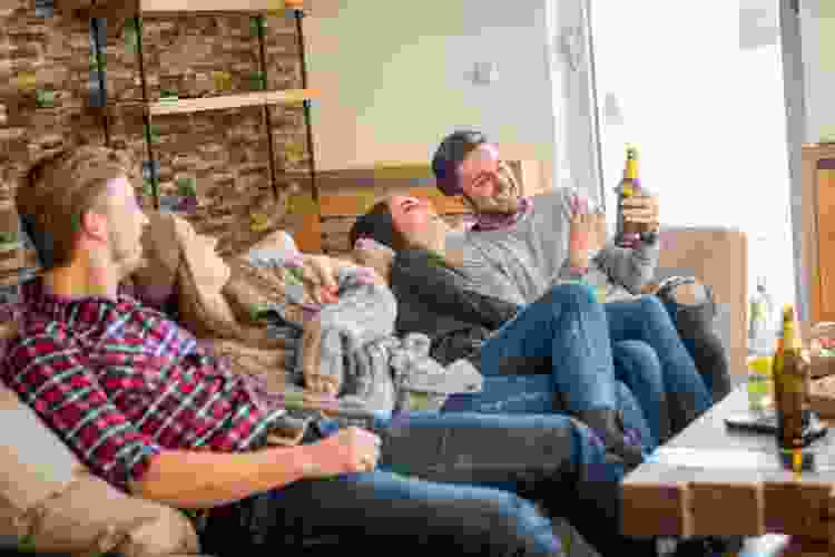 two couples drinking and watching movies at home