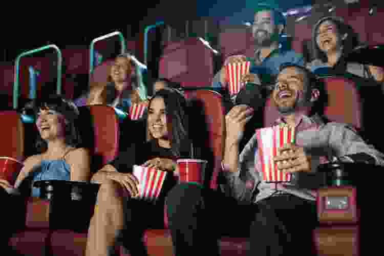 group of friends watching movie in theater