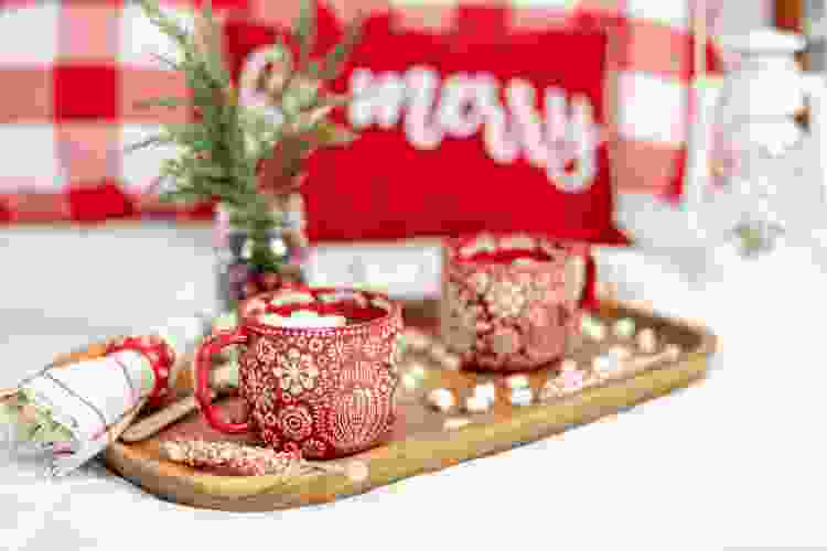 red holiday coffee mugs on tray