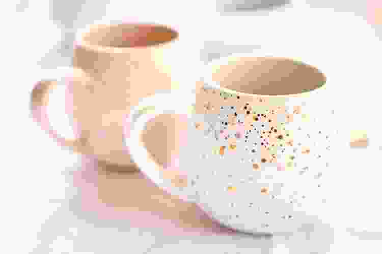 pink and white coffee mugs with gold flakes