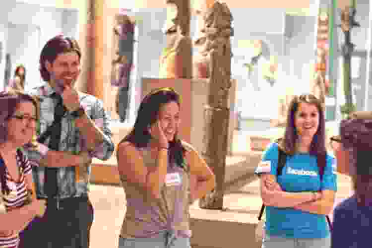 tourists listening to guide at museum