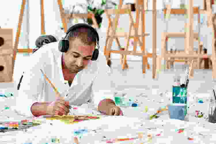 person painting while listening to music 