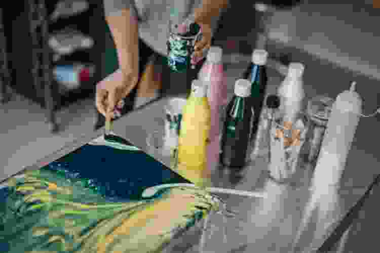 painting canvas with colored acrylic paints in bottles