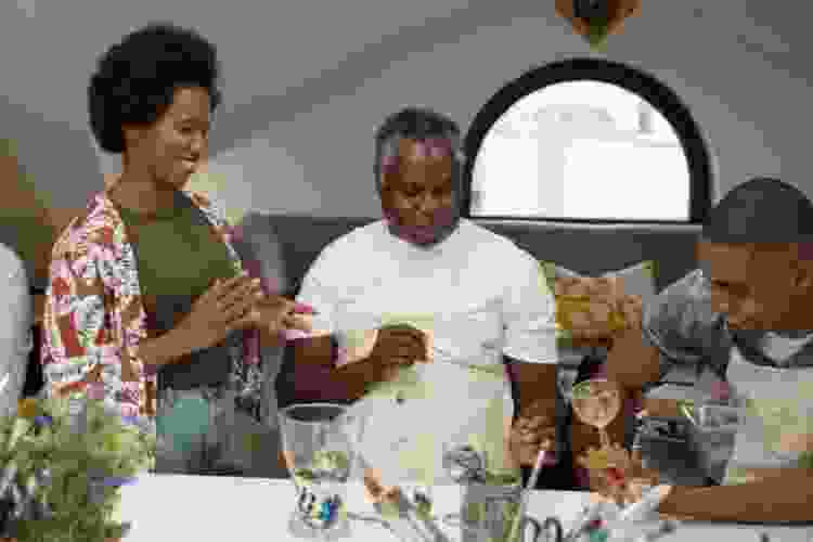 group of friends painting wine glasses in paint class