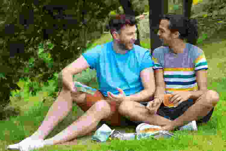 couple enjoying a picnic in the green grass of a park