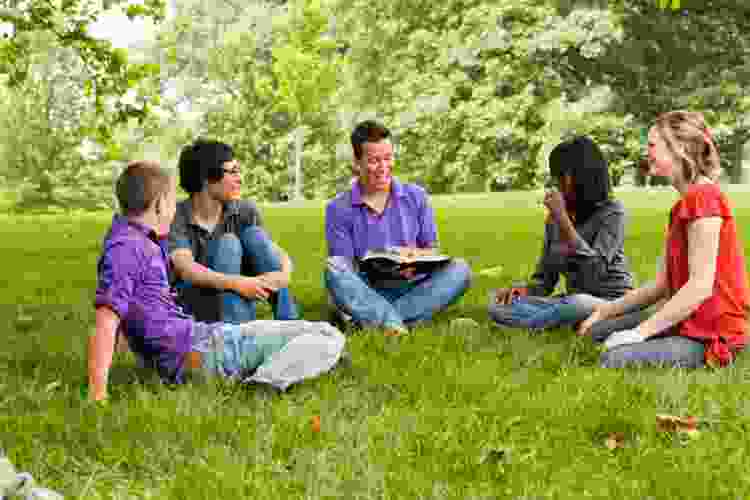 group of friends chatting in the park