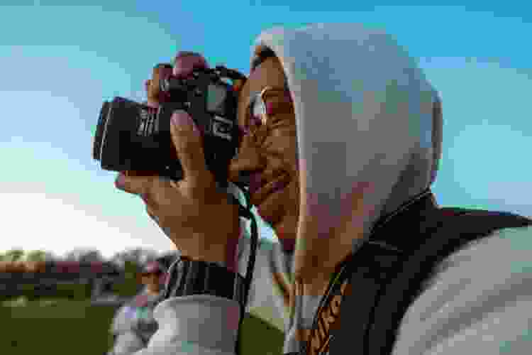 man taking photos outdoors with digital camera