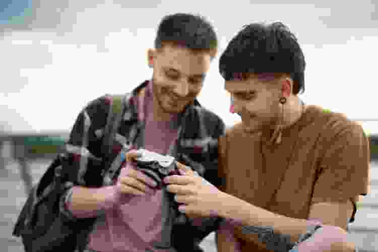 guys looking at film camera together