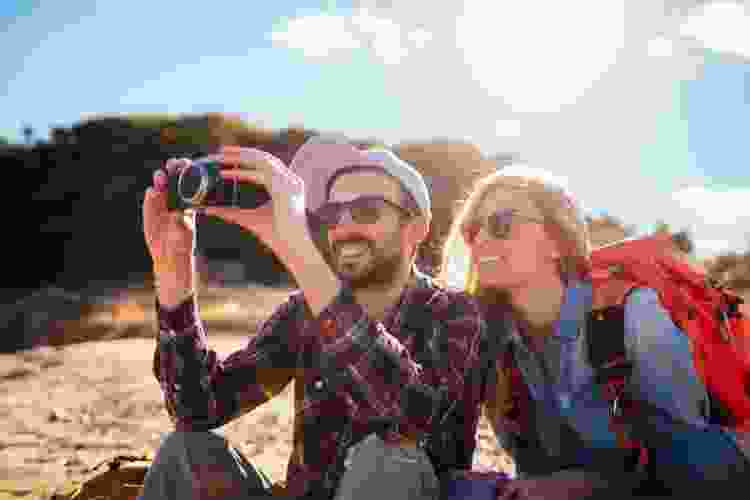 couple taking photos together with film camera