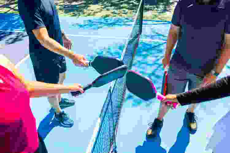 four people prepping for pickleball 