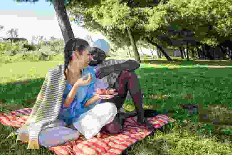 couple enjoying picnic in the park