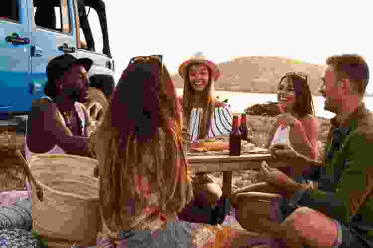 group of young people enjoying picnic with a view