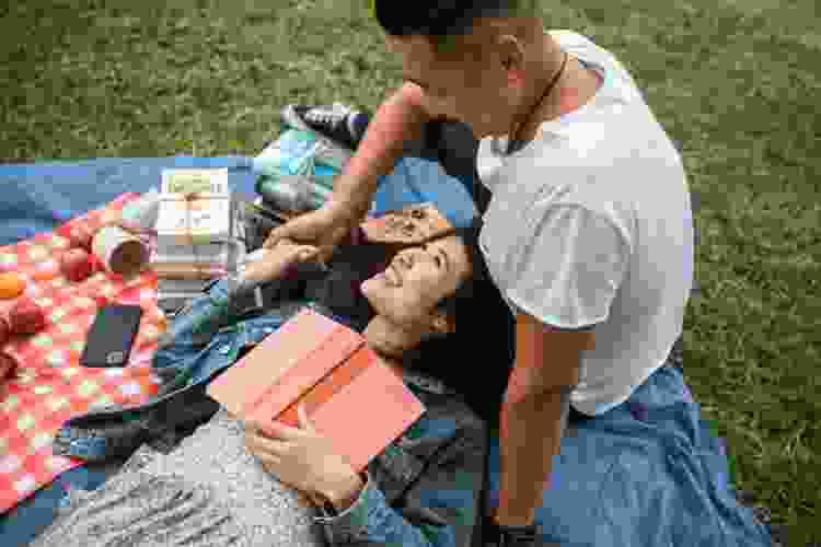 young couple enjoying picnic together