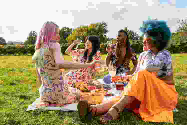 group of friends enjoying park picnic