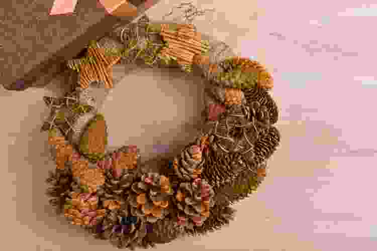 wreath made of twigs, pinecones and dried autumn leaves