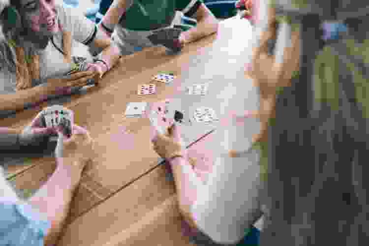 group of friends playing cards fun free date idea 