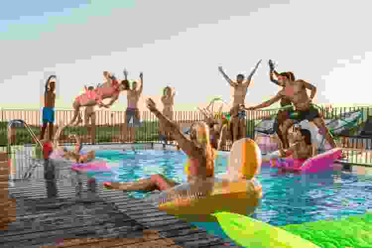 large group of teens partying in a pool