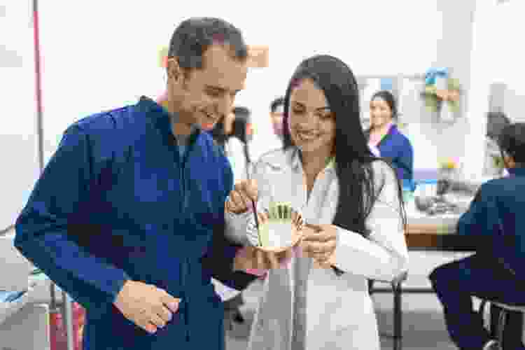 couple painting bowl in pottery class