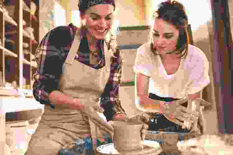 woman molding clay in pottery class