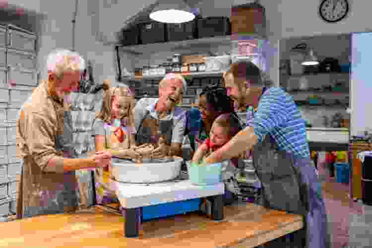 group of people making pottery in pottery studio