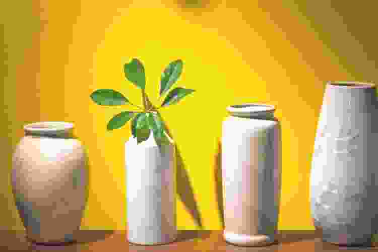 white ceramic vases with yellow background