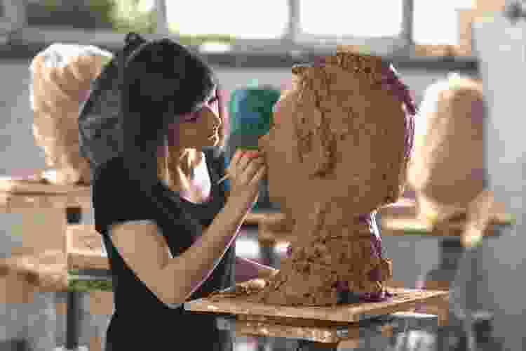 molding clay in pottery studio