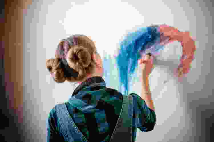 woman practicing her watercolor art on canvas