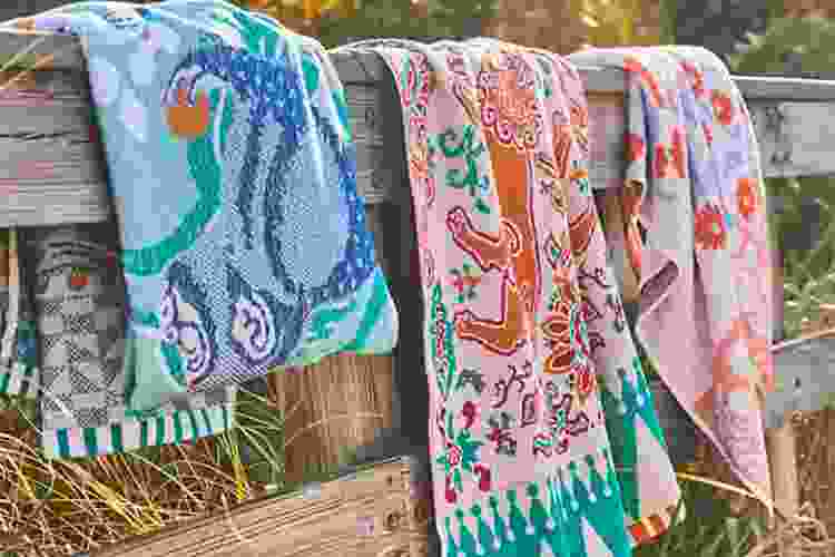 set of pretty beach towels hanging on the boardwalk