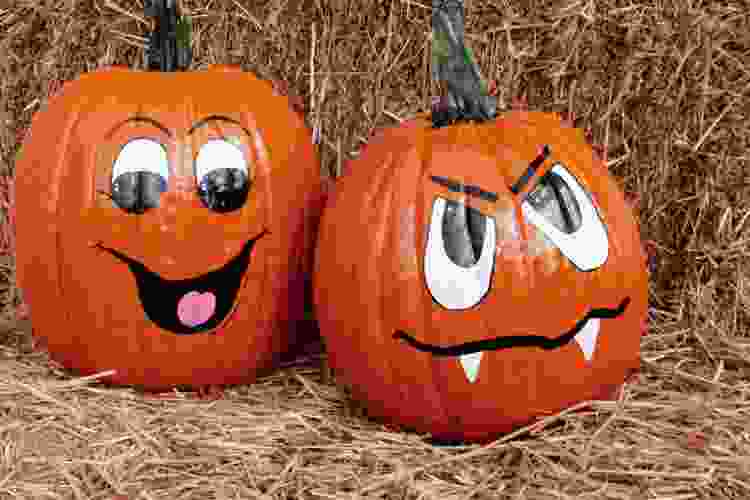 mini pumpkins with silly faces painted on them