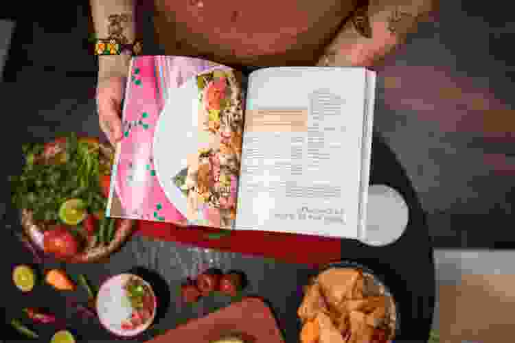 hands holding magazine with cooking recipe