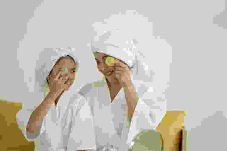 mother and daughter wearing plush bathrobes and towel wraps