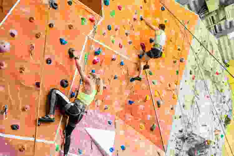 couple climbing indoor rock wall