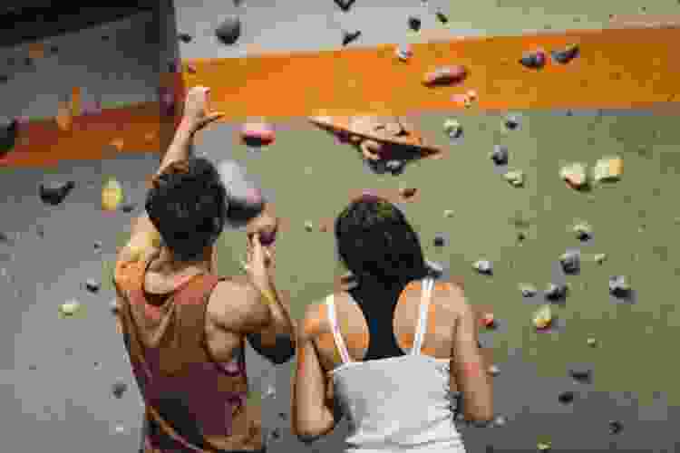 couple preparing to climb indoor rock wall