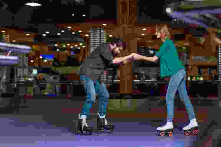 couple roller skating in rink