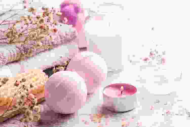 pink bath bombs on counter with candles