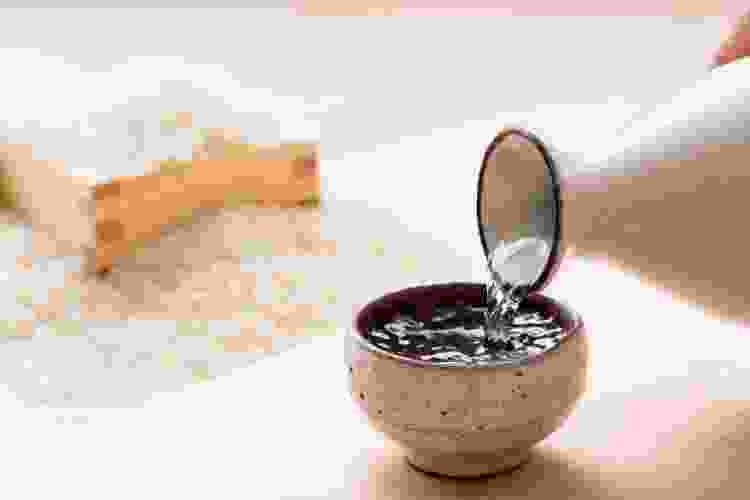 pouring sake into small cup